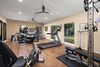 A spacious home gym with a variety of exercise equipment.